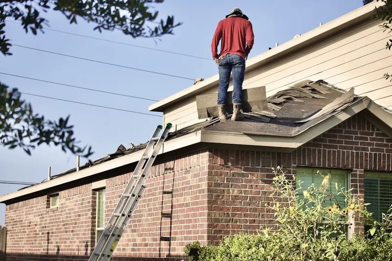 Professional roofer working on a residential roof in Oakland Park District
